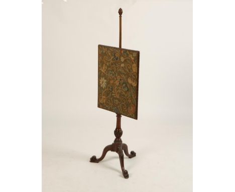 A GEORGE III MAHOGANY POLE SCREEN with a petit point banner in a carved frame, with a conforming baluster shaft with a downsw