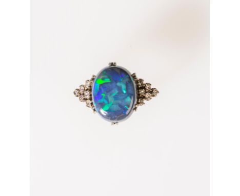 A 'BLACK OPAL' COCKTAIL RING, the large 'opal' cabochon in double claw setting, to an unmarked yellow gold shank, each should