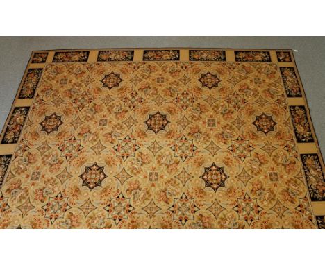 AN ENGLISH NEEDLEWORK CARPET of Victorian design, the pale beige ground worked with numerous pastel shaded multi-coloured flo