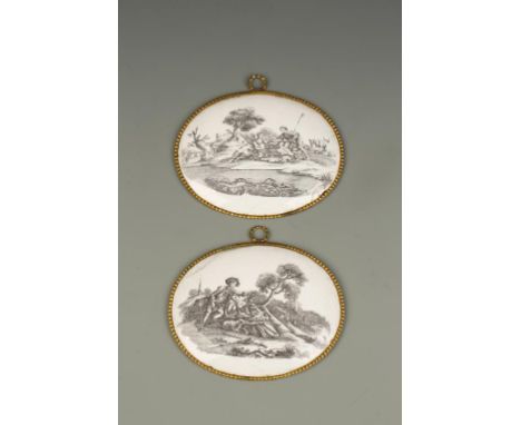 A PAIR OF "BATTERSEA" ENAMEL PLAQUES, oval shaped with gilt metal frames, printed in black with Romantic classical scenes, be