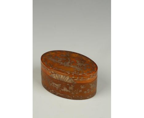 A FRENCH HORN SNUFF BOX, the oval box with silver pique work decoration, each side showing a dog chasing a bird in a foliate 