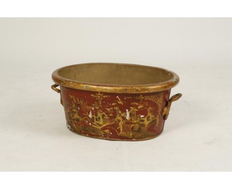 A "TOLE" WARE BASIN of broad oval form with twin cast gilt metal carrying handles and all over decorated in red and gilt orie