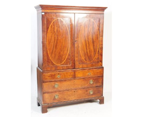 Late 18th century George III mahogany oval inlaid wardrobe / closet. Having a flared top, inlaid decorated panels with a two 