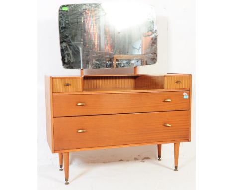 A retro mid 20th century teak dressing table. The dressing chest having a rounded edge rectangular mirror back over dressing 