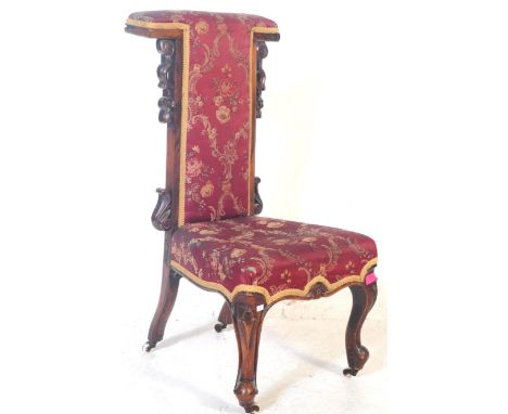 A 19th century Victorian mahogany upholstered prie dieu prayer chair chair. The chair having carved scrolling acanthus to the