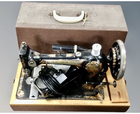 A vintage Jones sewing machine, in case, electrified.