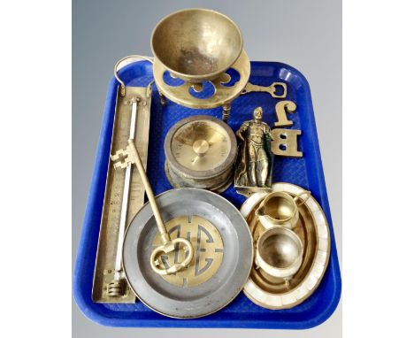 A tray containing antique and later brassware including figural door knocker, oversized key, trivet, thermometer, brass cased