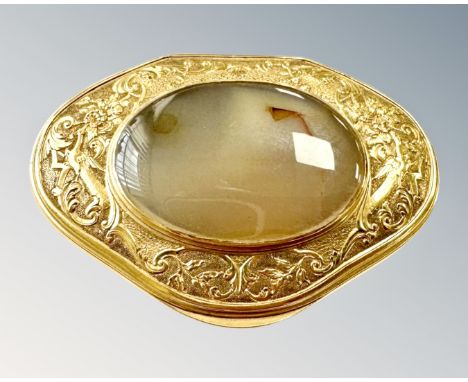 A 19th century yellow metal (presumed gold) and agate mounted snuff box, of cartouche shape with foliate-embossed detail to t