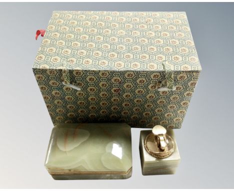 A Chinese fabric upholstered box containing an onyx cigarette case and lighter.