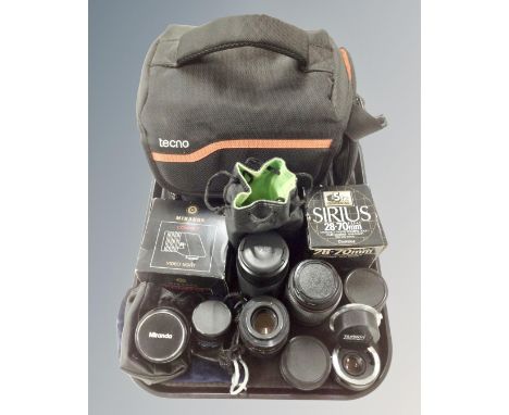 A tray containing Tecno camera bag together with a quantity of assorted camera lenses including Sigma, Miranda, Tokina etc. t