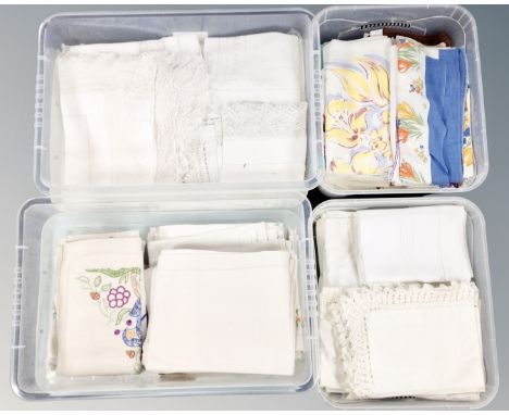 Four plastic storage boxes with lids containing vintage and later linen.