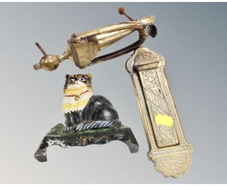 A vintage cast iron cat doorstop together with an antique brass door knocker and letter box.