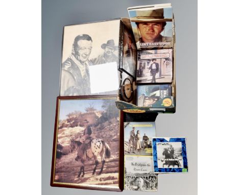 A box containing John Wayne wall clock and framed prints, vintage super 8 film reels including John Wayne, She Wore Yellow Ri