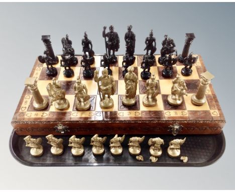 A wooden chessboard with painted metal pieces. (a/f)