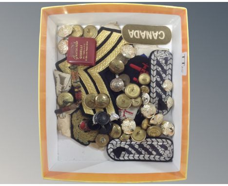 A box of mixed service button and sew on badges and insignias  