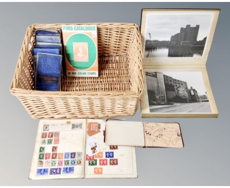 A basket containing a photograph album of monochrome photos of Newcastle and London, folded vintage Bartholomews maps of Nort