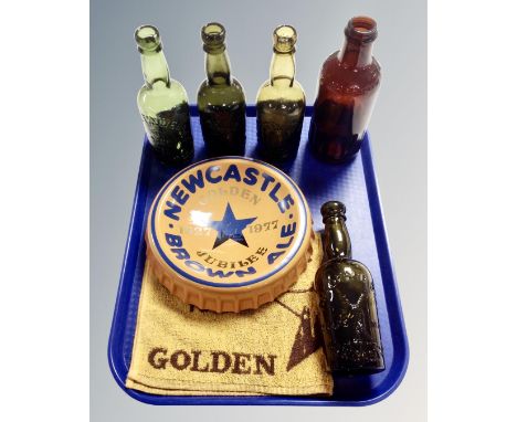 A Henry W. King &amp; Company Newcastle Brown Ale bottle top ash tray together with a Newcastle Brown Ale bar cloth, three vi