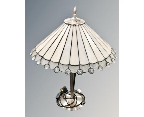 A contemporary table lamp with Tiffany style leaded glass shade.