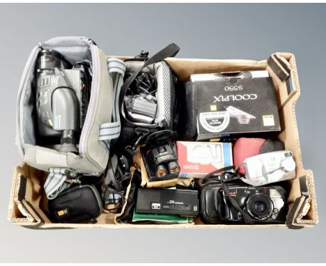 A box containing assorted instant and digital cameras, camera bags, Hitachi video camera, field glasses.