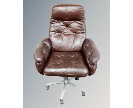 A Danish Göte Möbler office swivel reclining armchair, upholstered in a brown button leather.