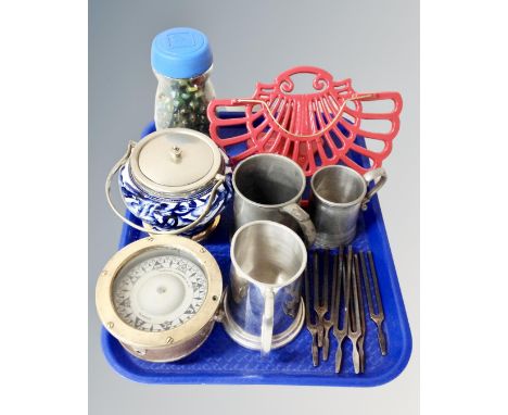 A tray containing a brass ship's compass, a jar containing glass marbles, a contemporary cast iron menu stand, tankards, tuni
