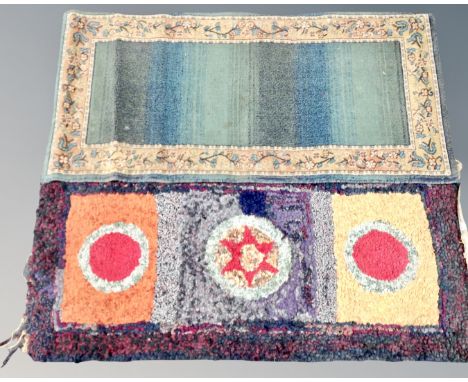 A vintage Clippy mat together with a machine made carpet runner on green ground.