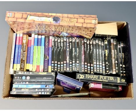 A box containing Harry Potter and the Philosopher's Stone board game by Mattel, a large quantity of Harry Potter DVDs, hardba