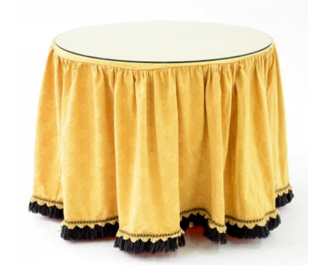 A MODERN TRIPOD TABLE BASE COVERED IN GOLD FABRIC WITH GLASS TOP 