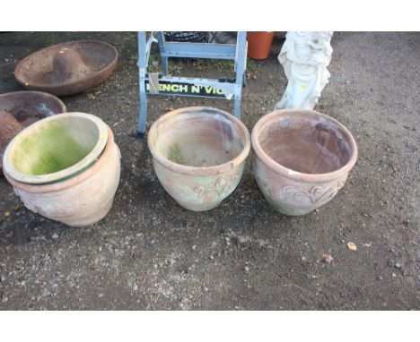 Three terracotta planters and a glazed planter