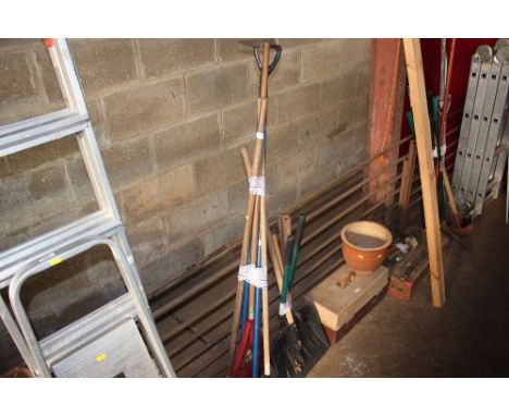 A bundle of long handled gardening tools 