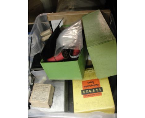 A box of vintage camera developing accessories, lenses, etc