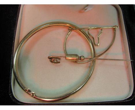 A 14ct tie clip, 9ct bangle and tie pin