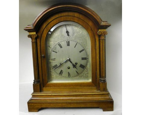 A Gustav Becker Quarter Chiming Bracket Clock:
an arch-topped mahogany case with columns aside silver dial.   Chime/silent su