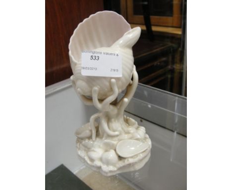 A Royal Worcester conch shell on coral