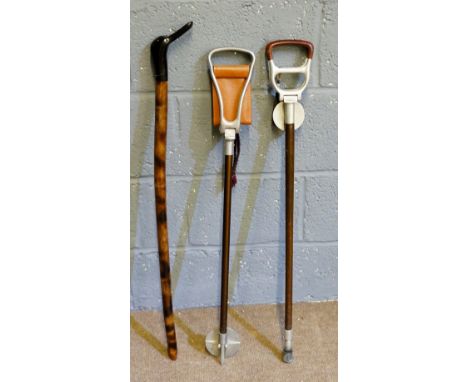 A collection of walking sticks to include: two seat sticks; a walking stick with painted black swan's head handle (3)