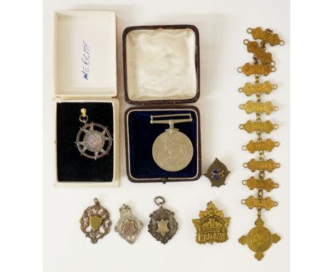 A quantity of badges/medals to include: a War Medal 1939-1945 (lacking ribbon); a silver medal awarded by British Railways fo