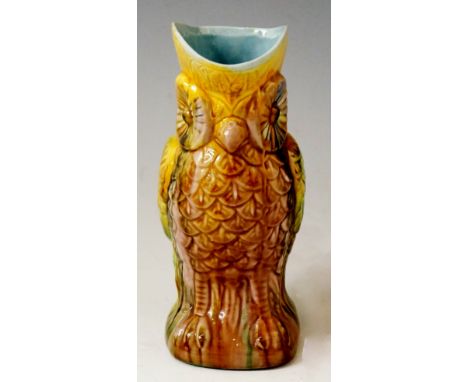 A majolica owl jug, the outer glaze in yellow, green, purple and brown, the inner glaze in light blue, 19cm high, 13.5cm wide