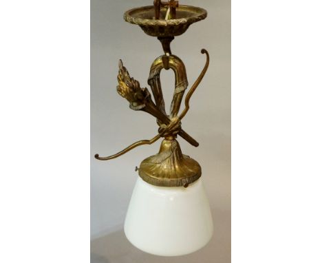 A lacquered brass ceiling light with foliate and laurel cast corona with hook issuing a flambeau torch, bow and tassel above 