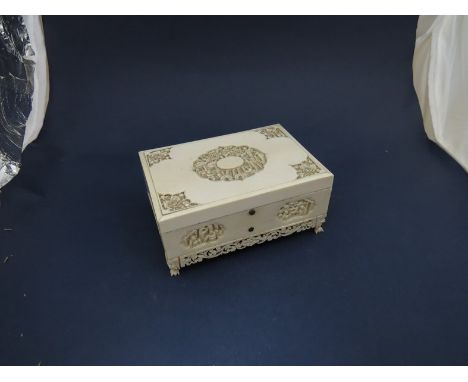 A circa 1900 ivory wavy trinket box with chinoiserie carved detail, 5.5cm x 12cm x 8.5cm