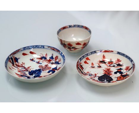 An 18th Century Lowestoft polychrome porcelain Redgrave type "Dolls House" pattern tea bowl and two graduated saucers. Bowl c