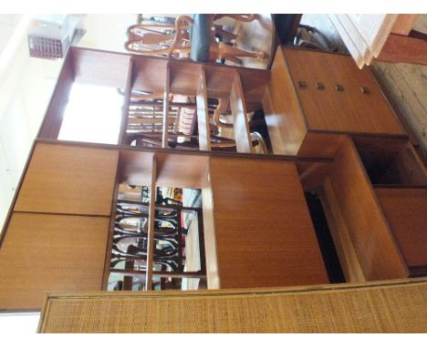 Two 1970's teak G Plan tall units comprising shelves, cupboards and drawers