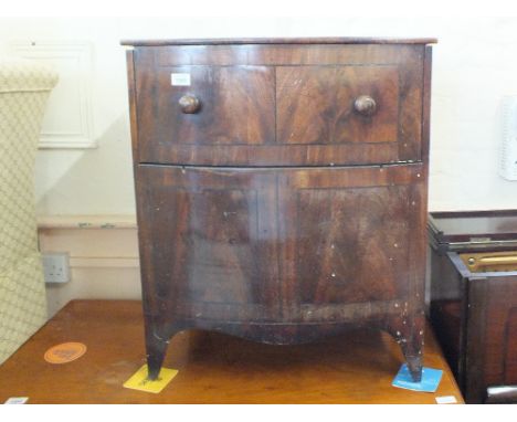 A Georgian mahogany bow front rising top commode