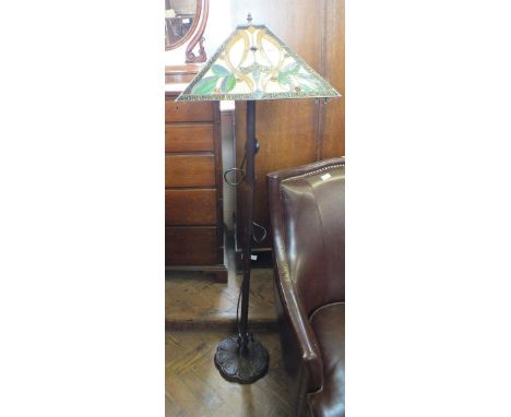 A metal standard lamp with Tiffany style shade