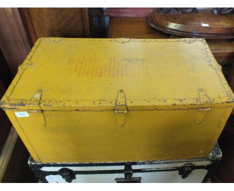 A yellow painted metal bound trunk