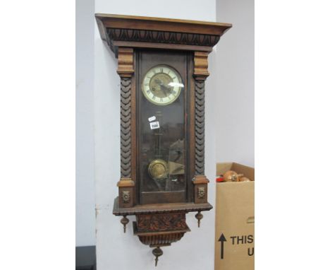 A Late XIX Century Walnut Cased Viennese Wall Clock, with eight day movement, black Roman numerals to cream chapter ring.