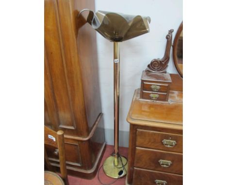 A Standard Lamp, with a plastic wavy light shade on a circular base.