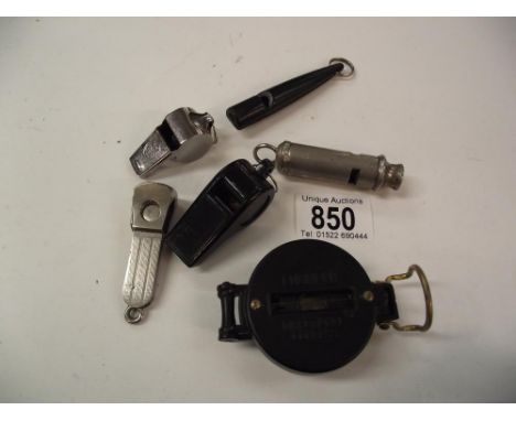 A quantity of whistles, a cigar cutter and an engineers directional compass 