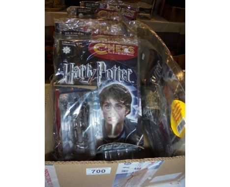 A quantity of Harry Potter chess pieces and magazines 