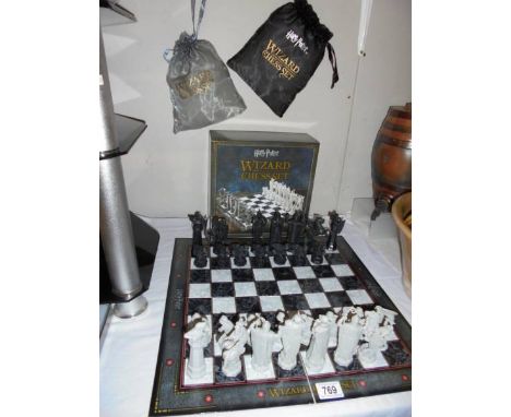 A boxed Harry Potter chess set. Wizard missing, black pawn, black knight and white castle. 