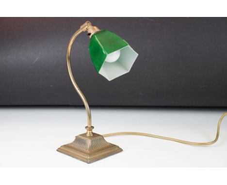 Art Deco style desk lamp having a green glass hexagonal light shade raised on a curved tubular arm on a reeded square base. 